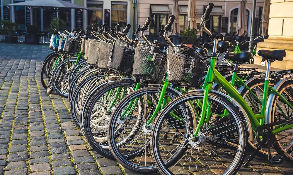 Reihe von Leihfahrrädern auf Kopfsteinpflaster in Prag